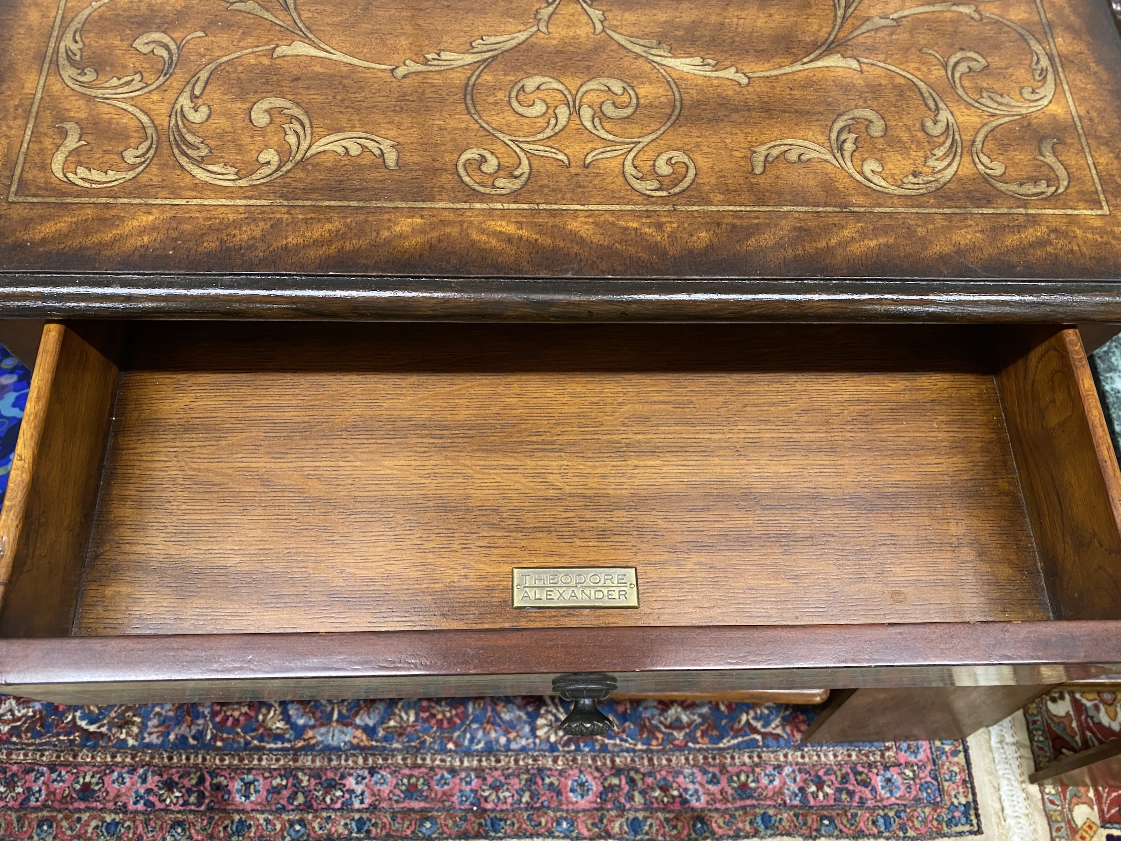 A Theodore Alexander faux marquetry walnut two tier table, width 66cm, depth 51cm, height 72cm